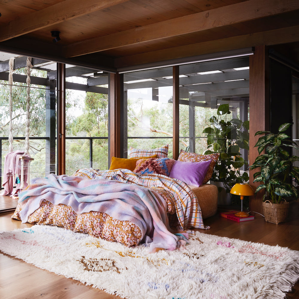 Juno Beni rug with multi-coloured large aztec inspired motifs on float style parchment woven rug. Finished with generous fringed edging. 